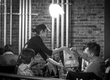 Waitress giving a Sushi Shop order in restaurant