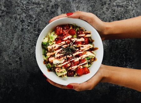 Hand holding a Sushi Shop's Tuna Poke Bowl